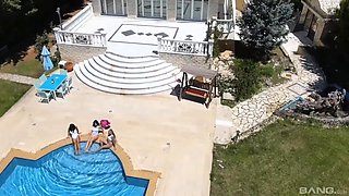 Three horny lesbian girls with big tits have fun playing with their dildo in the swimming pool