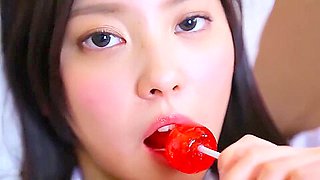 Nishida Natsume sucks a lollipop in school uniform