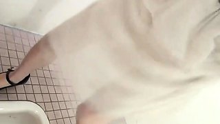 Asian peeing in public toilet