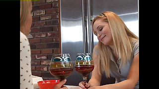 Two blondes explore each other's bodies in the kitchen