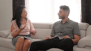 A mature asian woman with long hair plays with her natural big tits