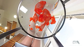 My Nylon Feet Squeezing Strawberry Juice on a Glass Table