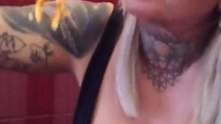 Blonde tattooed milf eats spaghetti on the toilet