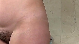 Mature Woman Takes off Her Clothes Except Her Bra in the Bathroom