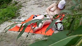 Wild Beach. Random Passerby Guy Peeps On River Bank Sunbathing Topless Beautiful Milf Outdoors. Outside. Naked In Public