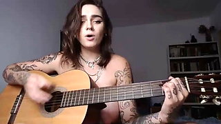 Busty Emo chick plays guitar and fingers asshole