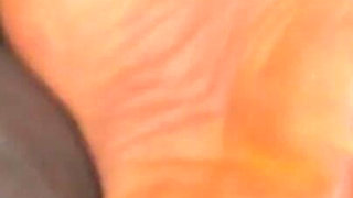 Ebony Girl Gives Her Feet a Massage with a Massage Gun