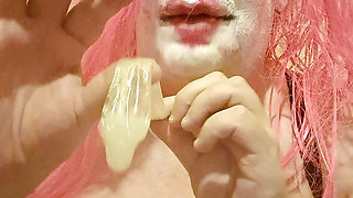 TV clown slut sucking out the contents of a condom
