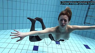 Hot blonde teen in stockings swims seductively