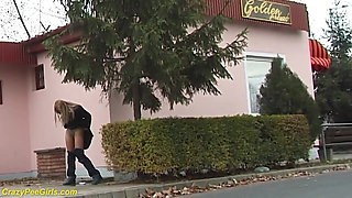 Beauty pissing on street behind bushes