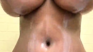 Ebony MILF vixen covers her big natural tits with milk