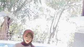 Hijab-wearing Woman Bathes Naked in an Open Swimming Pool