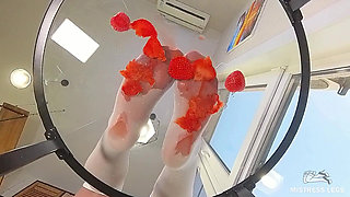 My Nylon Feet Squeezing Strawberry Juice on a Glass Table