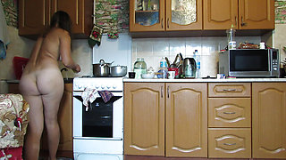 Naked hostess in the kitchen