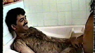 Really hairy Indian guy cuddling in the bathtub with his busty wife
