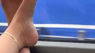 MILF seductress exposing her sexy little feet outdoors