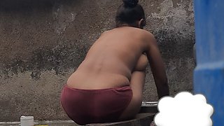 Desi Indian village bathroom in open courtyard wearing red tights bathing