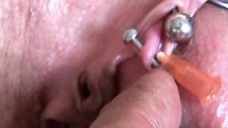 Real Clitoris piercing and through with a needle