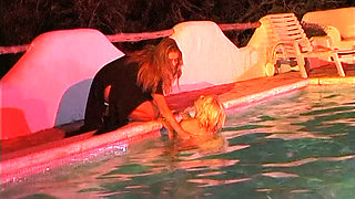 Two sexy lesbian chicks are swimming together in the swimming pool