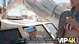 White bikini with red trim pulled down, she sucks him on the boat deck