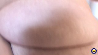 A voluptuous, older married woman engages in self-pleasure in the kitchen area.