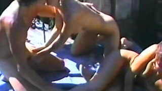 A Lucky Guy Bangs Two Babes Next to a Hot Tub