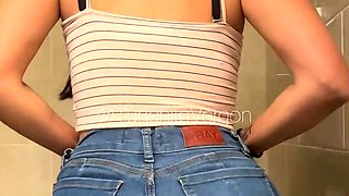 Sexy Latina undressing in a public restroom