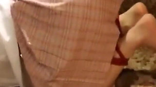 A Cute Little Dressed in a Jk Uniform Was Walking Around Barefoot on the Ground.