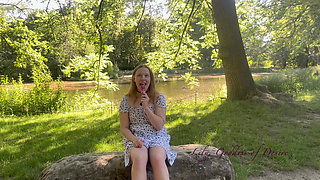 Innocent Girl Sits in the Park and Eats Lollipop Not Knowing That Her Panties Can Be Seen