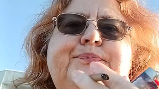 Bearded Lady try's to  lights  on windy beach!
