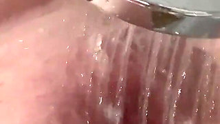 The Redhead Slut Masturbates Her Pussy with the Shower and Enjoys I