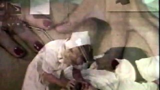 In a kitchen a sexy brunette playing with her big boobs