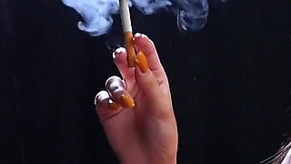 Sexy Lady in Red Is Smoking Two 100mm Reds