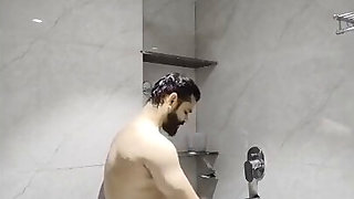 Bearded Indian dude fucks a Desi MILF in the shower from the back
