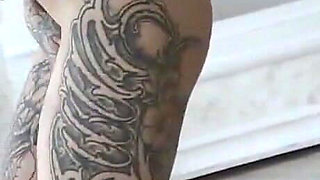 Plumpy tattooed MILF is dancing striptease