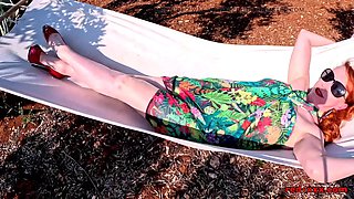 Red XXX stuffs her pussy with a toy in the hammock