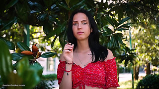 Sultry Brunette in Red Dress Smoking Rolled Cigarette