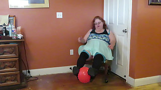 Nurse Vicki  plays with a rubber ball in a mini skirt, sexy stockings and high heel mini boots